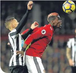  ??  ?? Paul Pogba gets to the ball despite the attentions of Dwight Gayle