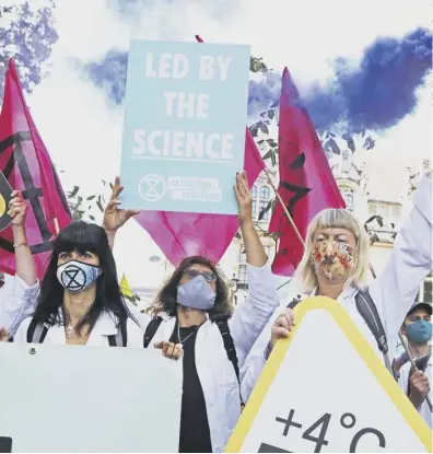  ??  ?? 0 Extinction Rebellion protesters make the point that their calls for greater action are backed by scientists