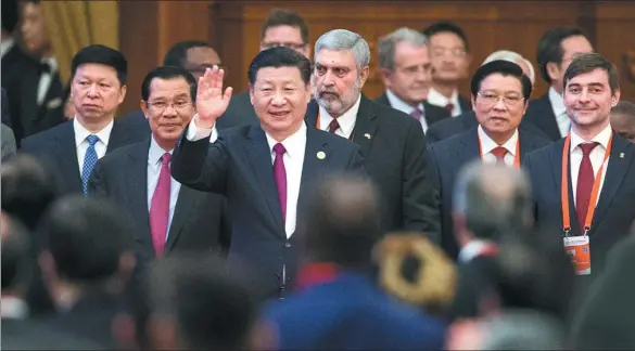  ?? XU JINGXING / CHINA DAILY ?? Xi Jinping, general secretary of the Communist Party of China Central Committee, walks into the meeting room on Friday with delegates who are in Beijing to attend the CPC in Dialogue with World Political Parties High-Level Meeting. The meeting is the...