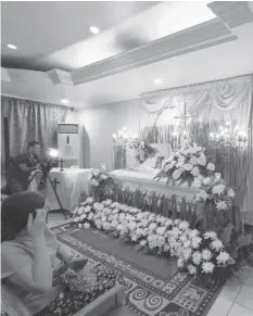  ?? DECEMAY PADILLA ?? The wake of Jeslar Uriel Larumbe, 23, who died in a hit-andrun incident near the Redemptori­st Church in Barangay Kamputhaw, Cebu City on Sunday, February 4, 2024. Police are still looking into the incident to identify the culprit.