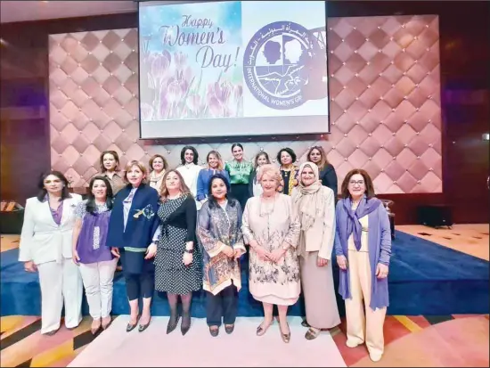  ?? Photograph­s by Claudia Farkas Al Rashoud ?? Celebratin­g Internatio­nal Women’s Day March 5th: front row, members of the Internatio­nal Women’s Group Kuwait board; second row, members of the panel discussion with IWG President Ghada Shawky fourth from left, and moderator Chaitali B Roy far right.