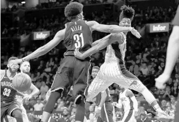  ?? JULIE JACOBSON/ASSOCIATED PRESS ?? Magic guard Elfrid Payton (2) passes the ball around Brooklyn Nets center Jarrett Allen (31) on Friday.