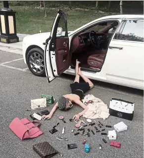  ??  ?? A woman lying on the floor as she poses for a picture with lipsticks and handbags in China. — AFP/courtesy of Wen Siyuan