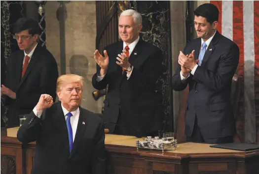  ?? Susan Walsh / Associated Press ?? Vice President Mike Pence and House Speaker Paul Ryan applaud as President Trump concludes his first State of the Union address last week on Capitol Hill. The country remains divided on many of his proposals.