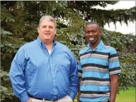  ?? MARIAN DENNIS — DIGITAL FIRST MEDIA ?? Darrin Wallace, left, stands with James Mureithi days before Mureithi leaves to return to Kenya. Mureithi traveled to the U.S. as part of a mission to raise awareness about his goal of bringing educationa­l centers back to Kenya. He has already raised...