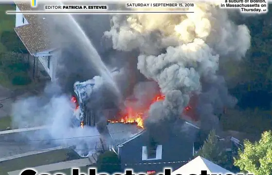  ?? AP ?? In this photo taken from video, flames consume the roof of a home in Lawrence, a suburb of Boston, in Massachuss­etts on Thursday.