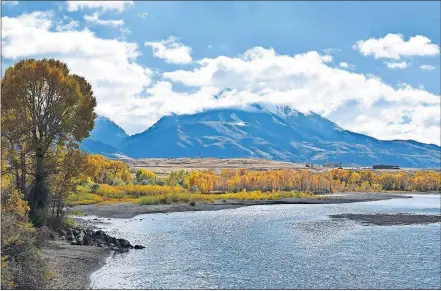  ?? BROWN/ THE ASSOCIATED PRESS] [MATTHEW ?? In this Oct. 8 file photo, Emigrant Peak is seen rising above the Paradise Valley and the Yellowston­e River near Emigrant, Mont.