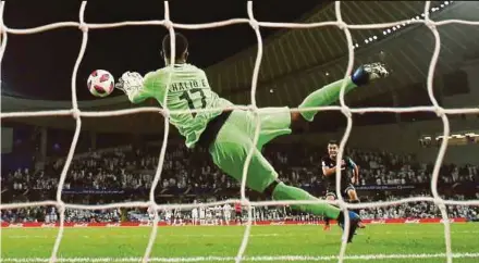  ?? REUTERS PIC ?? Al-Ain’s Khalid Eisa saves a penalty from Team Wellington’s Justin Gulley during the shootout in their Club World Cup match on Wednesday.