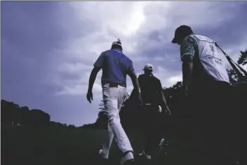  ?? ASSOCIATED PRESS ?? DUSTIN JOHNSON (center) and Harris English (left) walk up the fairway on the 18th hole during the final round of the Northern Trust golf tournament at TPC Boston Sunday in Norton, Mass.