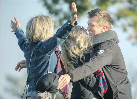  ?? STEPHEN B. MORTON/THE ASSOCIATED PRESS ?? Mackenzie Hughes of Dundas, Ont., right, hugs wife Jenna and his mother Sandra Hughes, left.