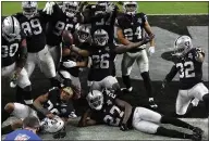  ?? JEFF BOTTARI — THE ASSOCIATED PRESS ?? Raiders cornerback Nevin Lawson ( 26) celebrates with teammates after recovering a fumble against the Denver Broncos on Nov. 15, in Las Vegas.