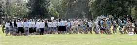  ?? PHOTO: SCOTT HAMMOND/STUFF ?? Marlboroug­h Boys’ College students on a ‘‘pay back’’ grundy run across the Marlboroug­h Girls’ College field.