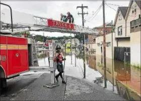  ?? FACEBOOK PHOTO ?? Darby Fire Co. 1 members use ladder truck to rescue residents after flood waters rose on MacDade Boulevard in the borough Monday.