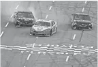  ?? SEAN GARDNER/GETTY IMAGES ?? Joey Logano, center, bumped Martin Truex Jr., left, in the final lap last Sunday at Martinsvil­le Speedway to take the checkered flag.