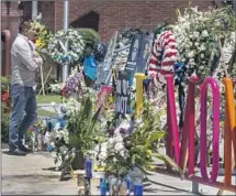  ?? ?? A MEMORIAL to the officers outside the El Monte Police Department continued to draw visitors a week after the shooting.