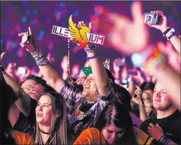  ??  ?? EDM fans dance along to Illenium, who hosted the first concert at Allegiant Stadium.