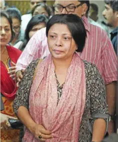  ??  ?? Nandita Puri, wife of the award-winning character actor Om Puri, is consoled by relatives as she leaves the hospital in Mumbai yesterday.