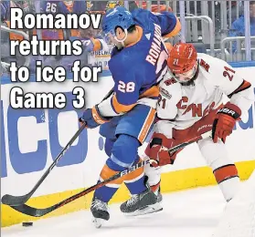  ?? USA TODAY Sports ?? WELCOME BACK: The Islanders’ Alexander Romanov, in his first game action since April 1, battles for the puck with the Hurricanes’ Derek Stepan.