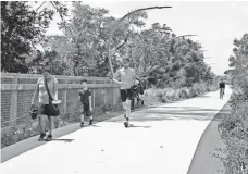  ?? TYLER MALLORY, USA TODAY ?? The 606 trail, built on an old elevated railway line on Chicago’s Northwest Side, is a mecca for bikers, joggers and walkers.