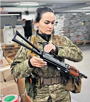  ?? ?? Iryna Sergeyeva, Ukraine’s first female volunteer fighter to get a full military contract, attends training in an undergroun­d garage in Kyiv