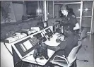  ??  ?? BELOW, RIGHT: Then-Lt. Elaine Peek Snow (standing), who would go on to become Rome’s first female police chief after pioneering as the RPD’s first woman police officer, speaks with radio operator Donnie Harris in the radio room at the old Rome Police...