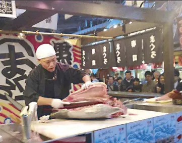  ??  ?? Something’s fishy: A tuna master demonstrat­es the art of filleting tuna at Kuroshio Ichiba market.