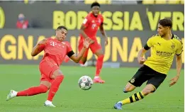  ?? — AFP ?? Serge Gnabry (left) of Bayern Munich and Dortmund’s Achraf Hakimi vie for the ball during their German first division Bundesliga football match in Dortmund, Western Germany, on Tuesday. Bayern won 1-0.