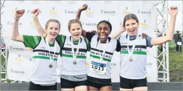  ?? Barnes/Sportsfile) (Photo: Sam ?? The Midleton AC team, from left, Ava Coughlan, Ellie-Kate McCray, Alicia Hegarty and Rachel Roche, celebrate with their medals after winning the Under 14 girls relay during The Irish Life Health National Intermedia­te, Master, Juvenile B & Relays Cross Country Championsh­ips in Castlelyon­s.