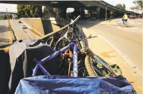  ?? Michael Macor / The Chronicle ?? Bicycles and bike parts block the sidewalk on Cesar Chavez Street below Highway 101 in San Francisco. An ordinance seeking to remove bicycle “chop shops” from city streets is expected to be passed by the Board of Supervisor­s on Tuesday.