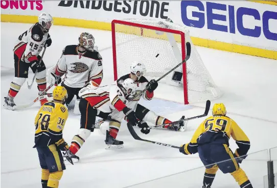  ?? PHOTOS: BRUCE BENNETT/GETTY IMAGES ?? Predators defenceman Roman Josi, right, scores the game-winning goal against the Anaheim Ducks on Tuesday in Nashville, Tenn.