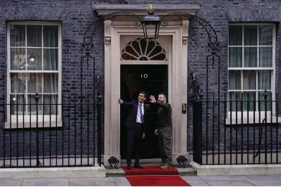  ?? The Associated Press ?? ■ Britain’s Prime Minister Rishi Sunak, left, gestures as he welcomes Ukraine’s President Volodymyr Zelenskyy on Wednesday at Downing Street in London. It is the first visit to the U.K. by Zelenskyy since the war began nearly a year ago.