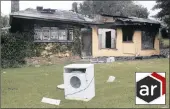  ?? PICTURE: GCINA NDWALANE ?? WASHED OUT: A washing machine stands broken and abandoned on the lawn of the farmhouse at Corby Hill Farm, outside Eshowe, which crowds torched, along with nearby sugar-cane fields.