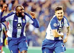  ??  ?? Alex Telles (R) scored a late penalty as Porto overcame Roma in extra time. - AFP photo