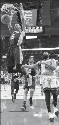  ?? AP/ERIC CHRISTIAN SMITH ?? San Antonio Spurs guard Dejounte Murray (5) dunks and all Houston Rockets guard James Harden can do is watch during San Antonio’s 114-75 series-clinching victory over the Rockets in Houston. Murray contribute­d 11 points, 10 rebounds and 5 assists off...