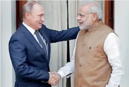  ??  ?? Russian President Vladimir Putin shakes hands with India's Prime Minister Narendra Modi ahead of their meeting at Hyderabad House in New Delhi, India, October 5, 2018. REUTERS