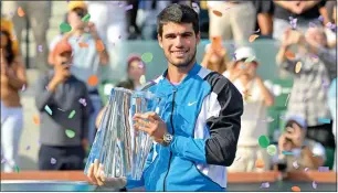  ?? — REUTERS ?? Carlos Alcaraz poses with the trophy after winning the Indian Wells Masters on Sunday.