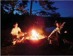  ?? Photo for The Washington Post by Melanie D.G. Kaplan ?? ■ Griffin Goldman and Zach Crisafulli toast marshmallo­ws outside their tent.