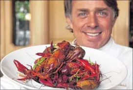  ?? ASSOCIATED ?? Chef John Besh holds the “French Crawfish Boil,” which includes Spanish tarragon and Tennessee truffles in his restaurant, “August,” in New Orleans. For the truly hot food scene in 2012, the South is where it’s happening. Besh, Hugh Acheson, Tim Love...
