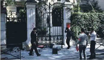  ??  ?? Computer equipment which was left for collection outside Iran’s mission in Paris lies smashed on the ground after protesters hurled it at the building’s gates during Friday’s disturbanc­e