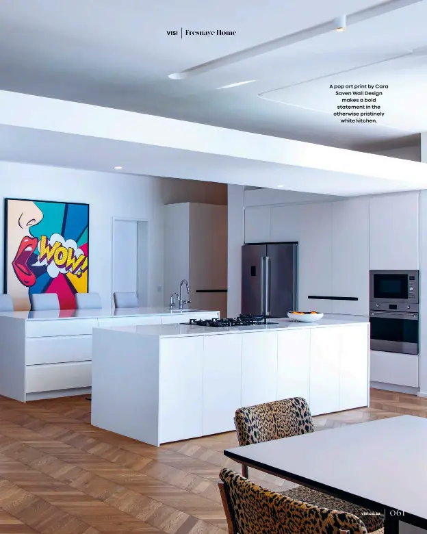  ??  ?? A pop art print by Cara Saven Wall Design
makes a bold statement in the otherwise pristinely
white kitchen.