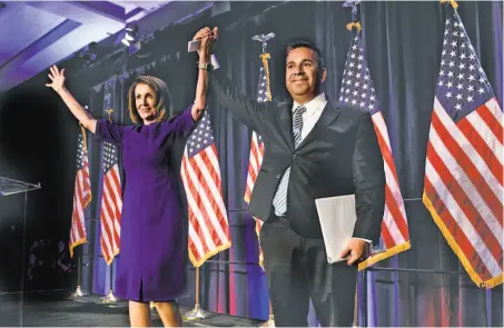  ?? Brendan Smialowski / AFP / Getty Images ?? Reps. Nancy Pelosi, D-Calif., and Ben Ray Luján, D-Minn., celebrate the incoming Democratic majority in the House.