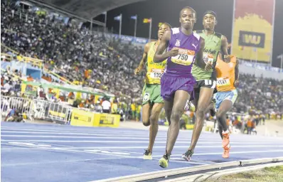  ?? FILE ?? Action from the Open Boys 5000m final at the ISSA/GraceKenne­dy Boys and Girls’ Athletics Championsh­ips at the National Stadium in March 2018.