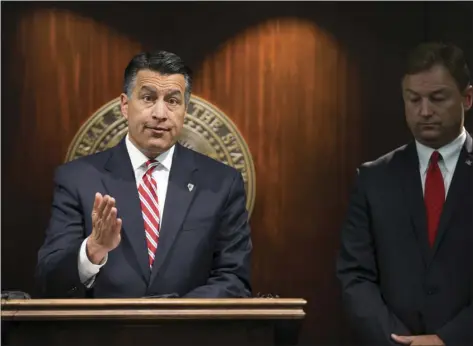  ??  ?? In this June 23 file photo, Gov. Brian Sandoval (left) and U.S. Sen. Dean Heller, R-Nev., give a news conference in Las Vegas where the senator announced he will vote no on the proposed GOP healthcare bill. A handful of Republican governors, including...