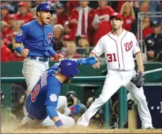  ?? BRIAN CASSELLA/TRIBUNE NEWS SERVICE ?? The Chicago Cubs' Ben Zobrist (18) scores behind teammate Willson Contreras in the fifth inning on a double by Addison Russell in Game 5 of the National League Division Series on Thursday in Washington, D.C.