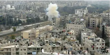  ?? AFP ?? Smoke rises from the Al Ethaa government held neighbourh­ood in eastern Aleppo during clashes. —