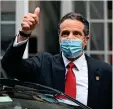  ?? AP ?? BACK IN BUSINESS: New York Governor Andrew Cuomo leaving the New York Stock Exchange after ringing its opening bell. —