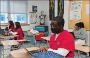  ?? DANA JENSEN/THE DAY ?? Joseph Imasuem and his fellow students review pulmonary system vocabulary Friday during their Honors Nursing Assistant class at Fitch High School in Groton.