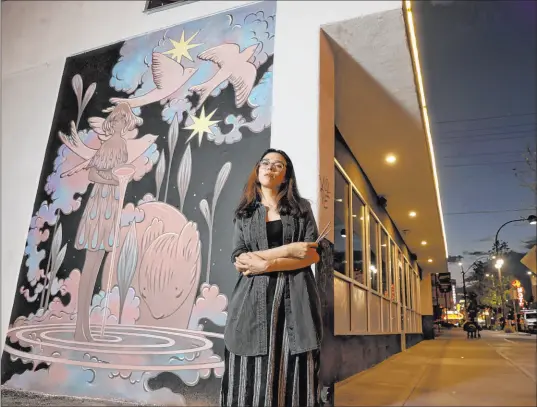  ?? Las Vegas Review-journal @Kmcannonph­oto ?? K.M. Cannon
Las Vegas artist Kim Sol painted her ethereal “Starlights & Rivulets” on the side of 11th Street Records.