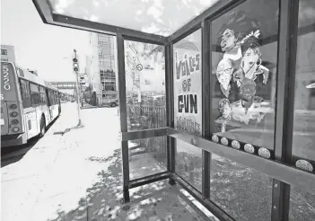  ?? MIKE DE SISTI/MILWAUKEE JOURNAL SENTINEL ?? A new bus stop mural at North 6th Street and West Highland Avenue carries a message that Milwaukee has a gun violence problem that needs to be stopped.