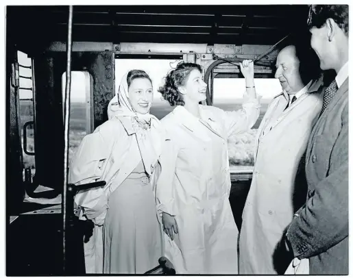  ??  ?? Princess Elizabeth pulls the locomotive’s whistle, while Princess Margaret smiles at Peter Townsend, the king’s equerry. FC Sturrock (second from right) was often named as the engine driver in this photo, when in fact he was minister of railways and harbours.